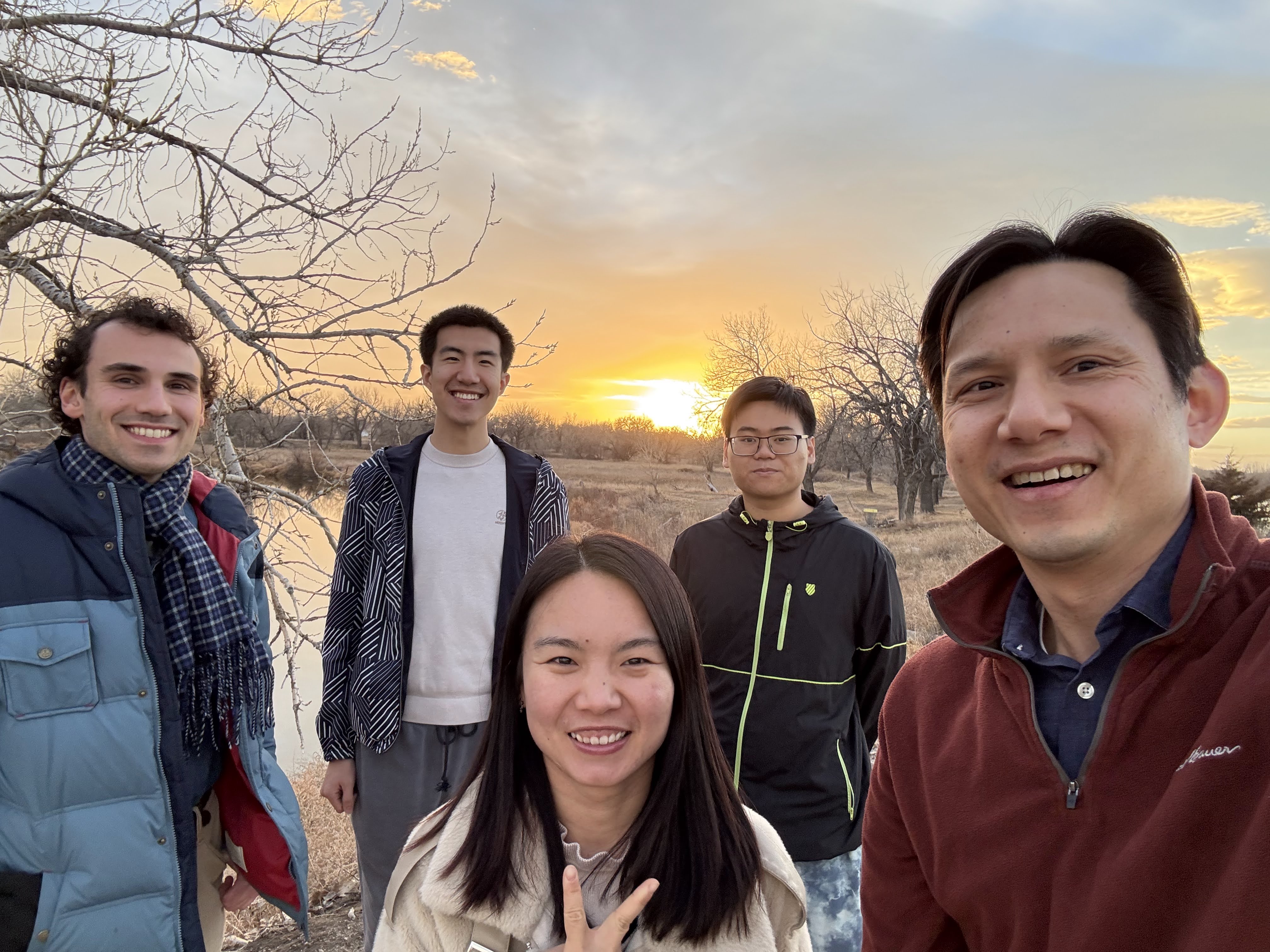 A small group of Young Disciples friends together outdoors at sunset